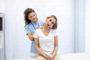 Female osteopath adjusting patients neck.
